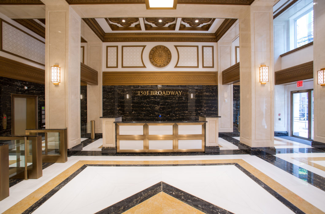 Custom light fixtures in art deco style make the 1501 Broadway Lobby renovation historically accurate.
