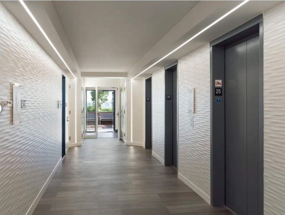 Elevator lobby of multi-family high rise provides wayfinding.