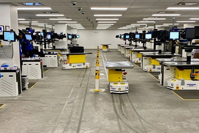 Checked baggage inspection system operations area at LaGuardia Airport Terminal B with back-of-house lighting designed by Goldstick Studio.
