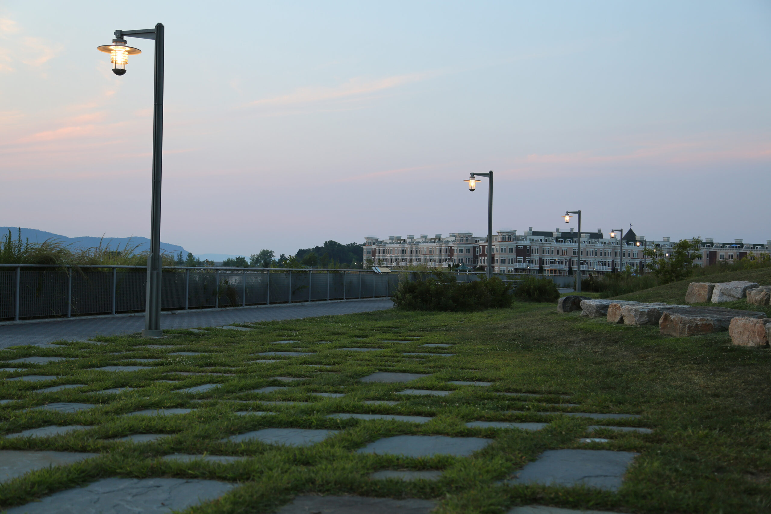 Marine-inspired pole lights illuminating a waterfront path at Hudson RiverWalk Park at Tarrytown.