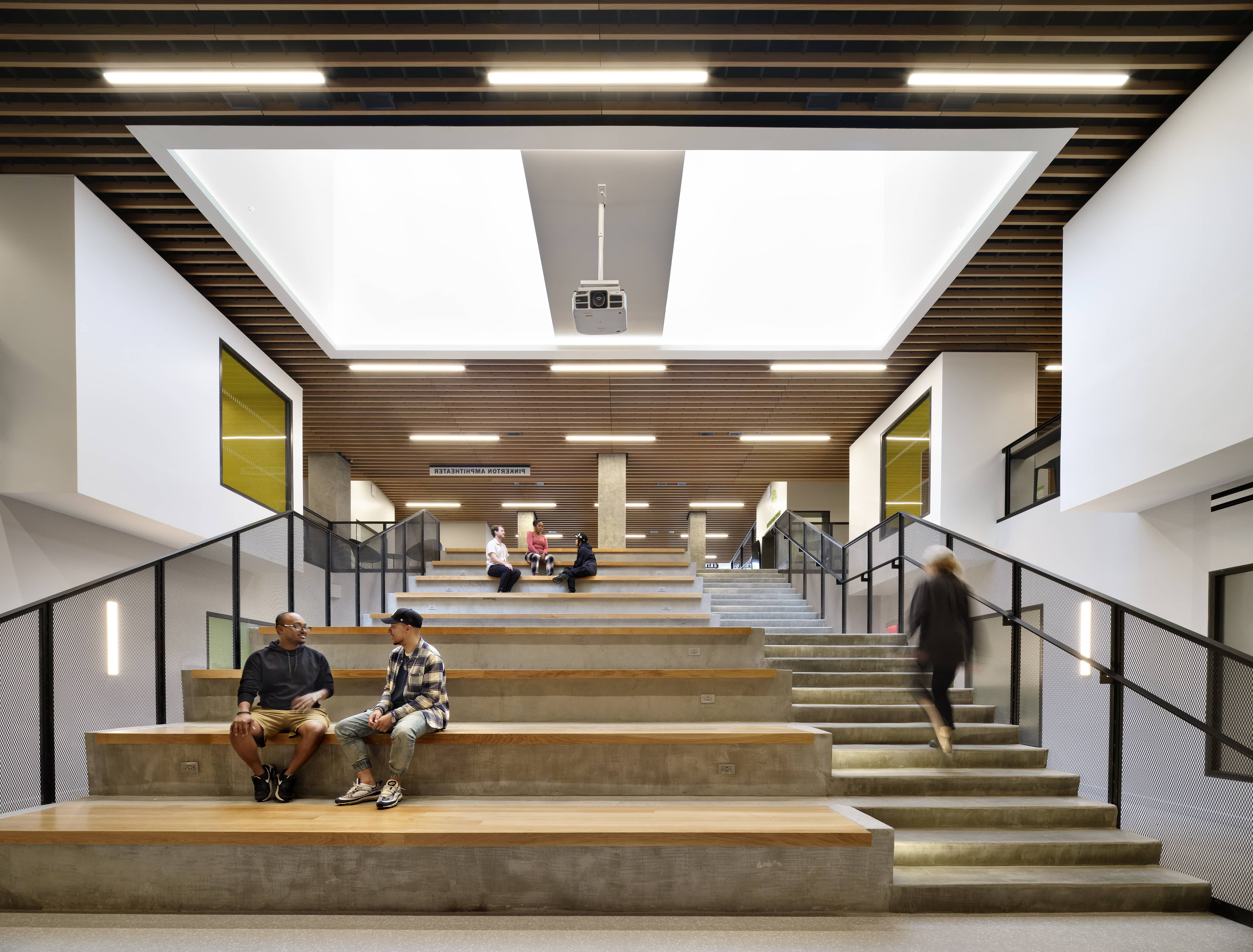 Community center with bright lighting over a series of steps and seated risers.