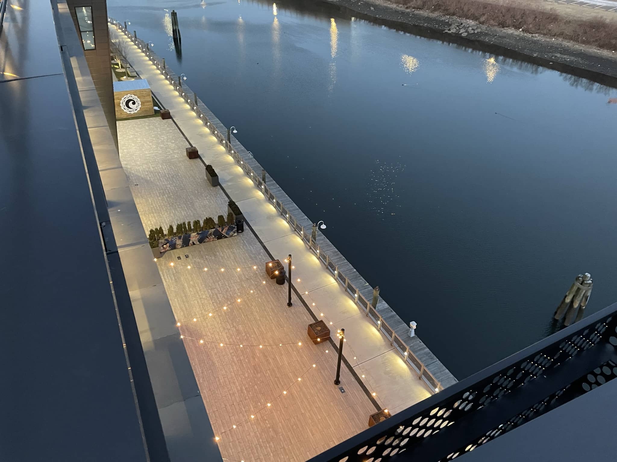 Outdoor pier with string lighting along the pier.