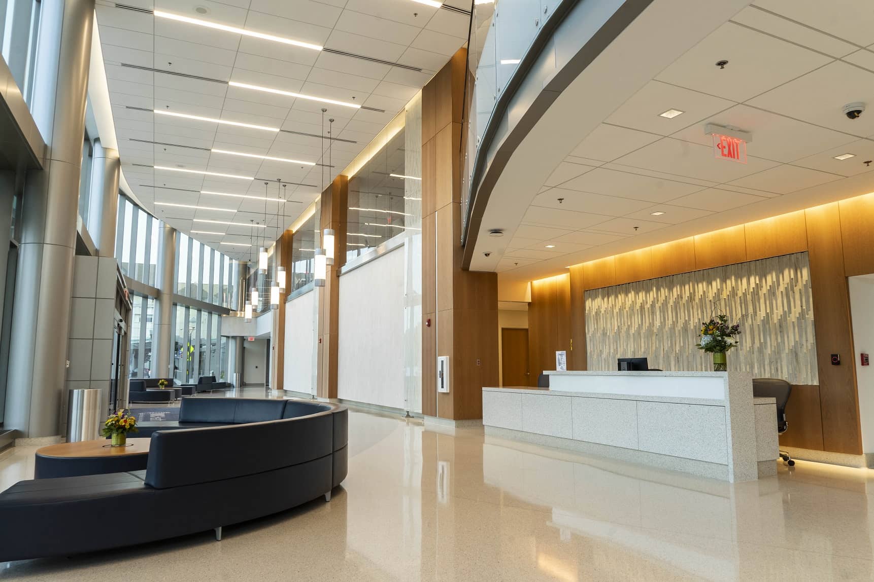 Lobby with bright lighting both above the atrium and behind the lobby desk.