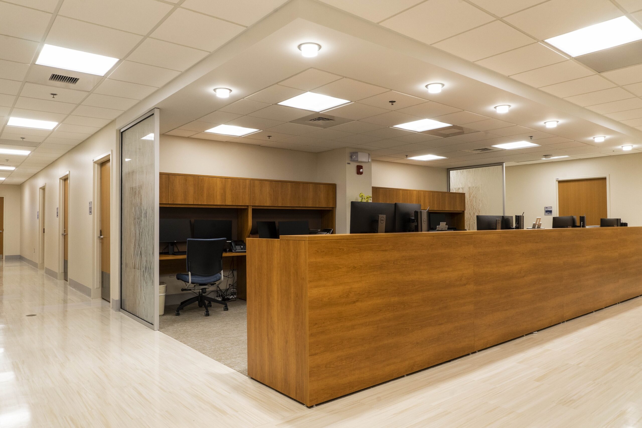 Westchester Medical Center Ambulatory Care Pavilion nurses station with recessed downlighting and luminous ceiling panels.