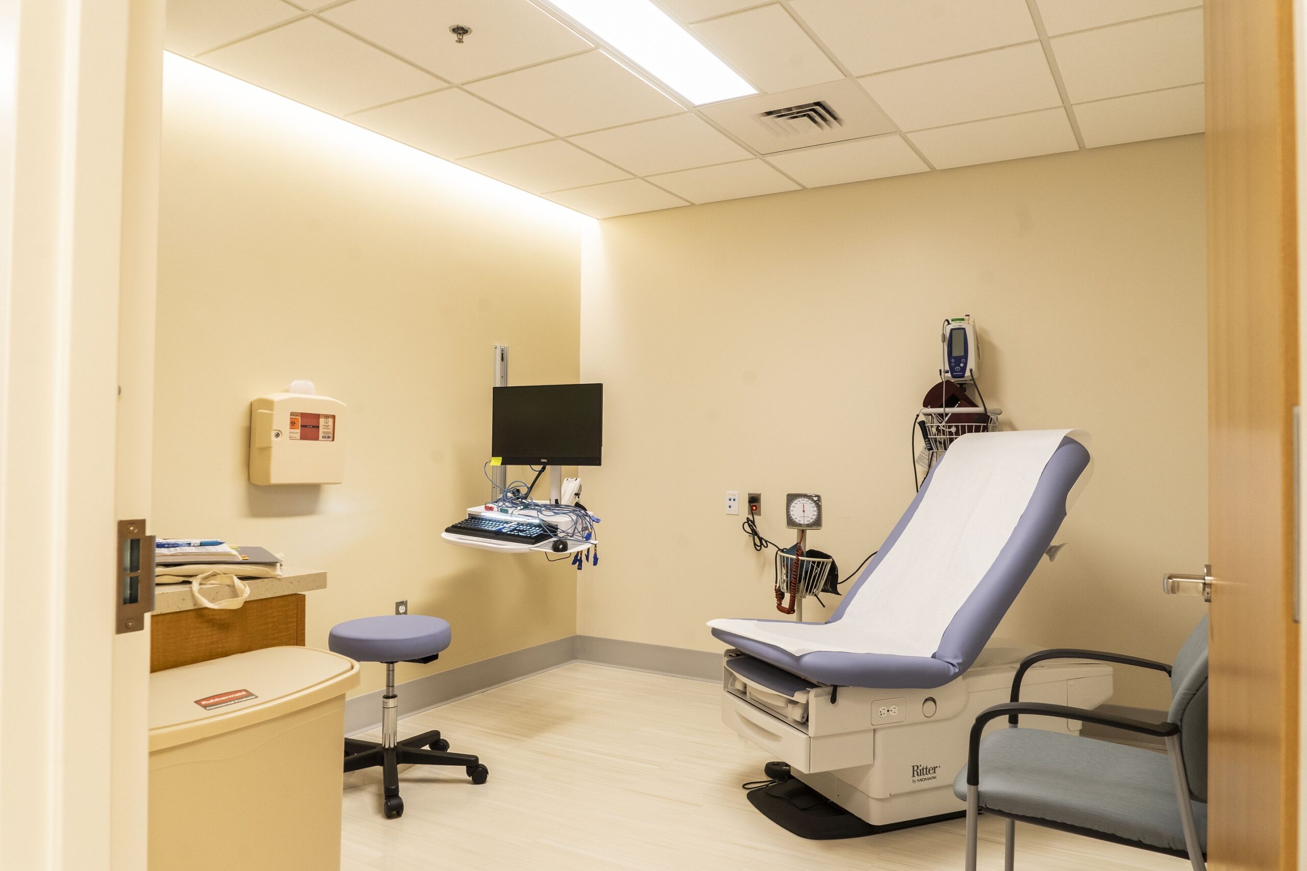 Westchester Medical Center Ambulatory Care Pavilion exam room with indirect cove lighting and luminous ceiling panels.