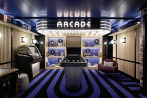 Airport lounge arcade with layered decorative lighting, illuminated game area, and integrated display lighting.