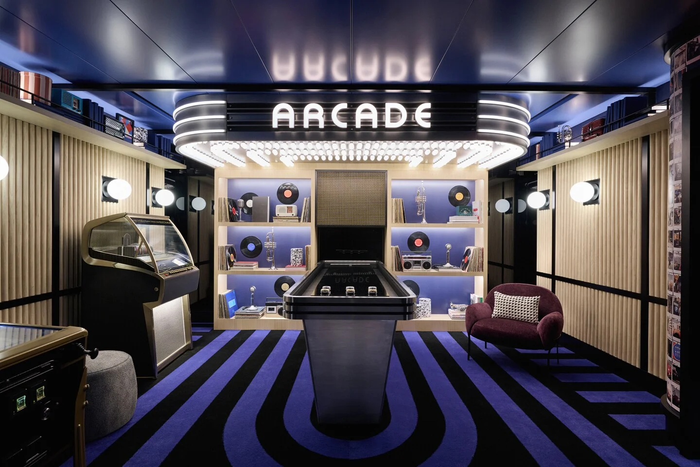 Airport lounge arcade with custom illuminated arcade fixture and integrated display lighting.