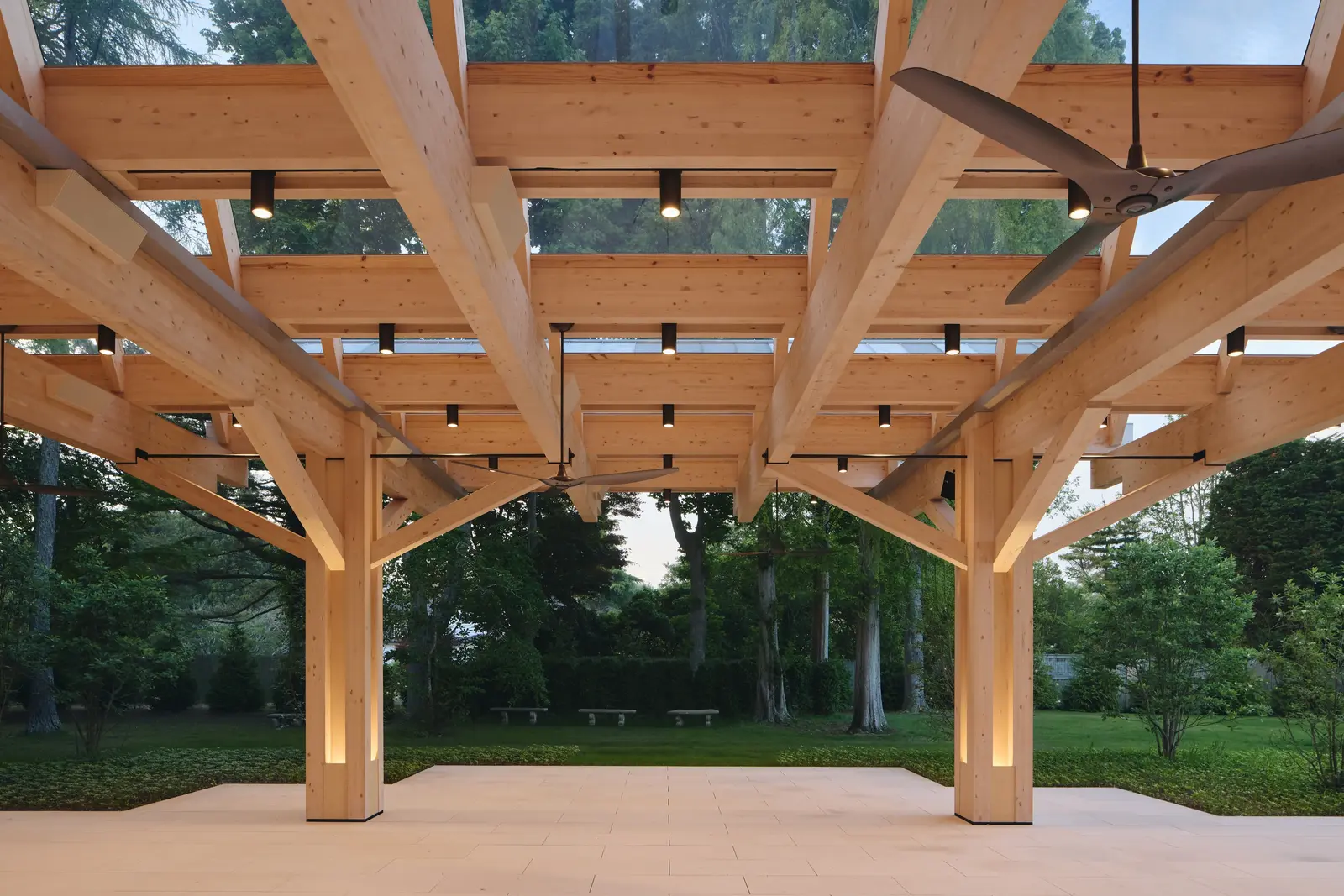 Timber pergola with integrated downlighting and column lighting highlighting the exposed wood structure.