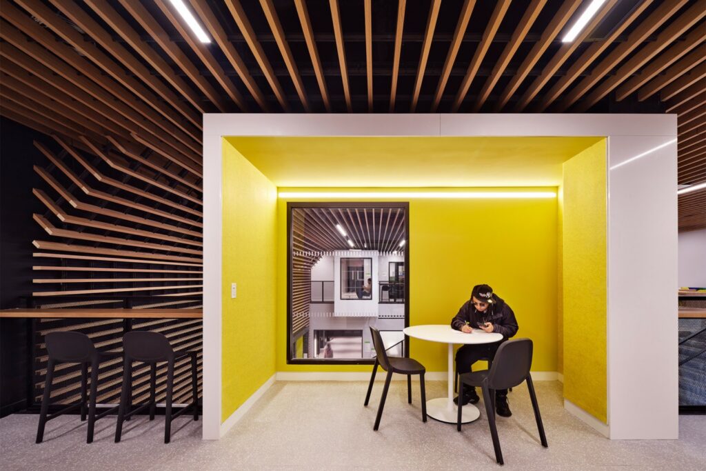 Chestnut Commons study alcove with integrated lighting and bright yellow acoustic walls