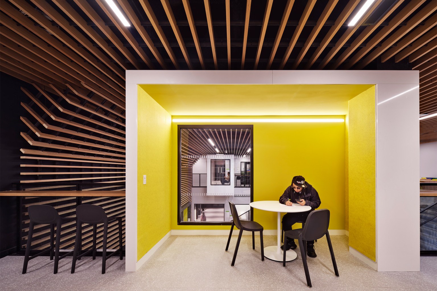 Chestnut Commons study alcove with integrated lighting and bright yellow acoustic walls