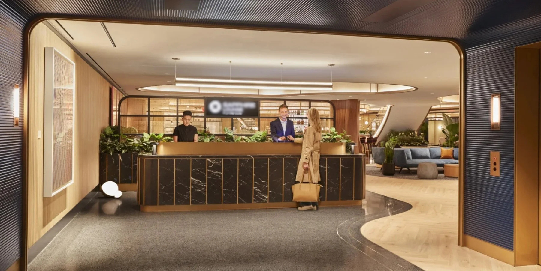 Airport lounge reception with layered architectural lighting, illuminated artwork, and suspended linear fixtures.