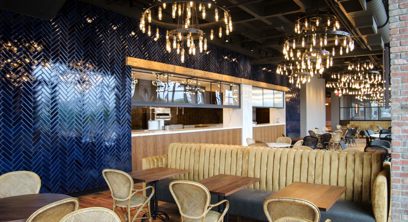 Cisco Brewers dining area with circular chandeliers and layered restaurant lighting