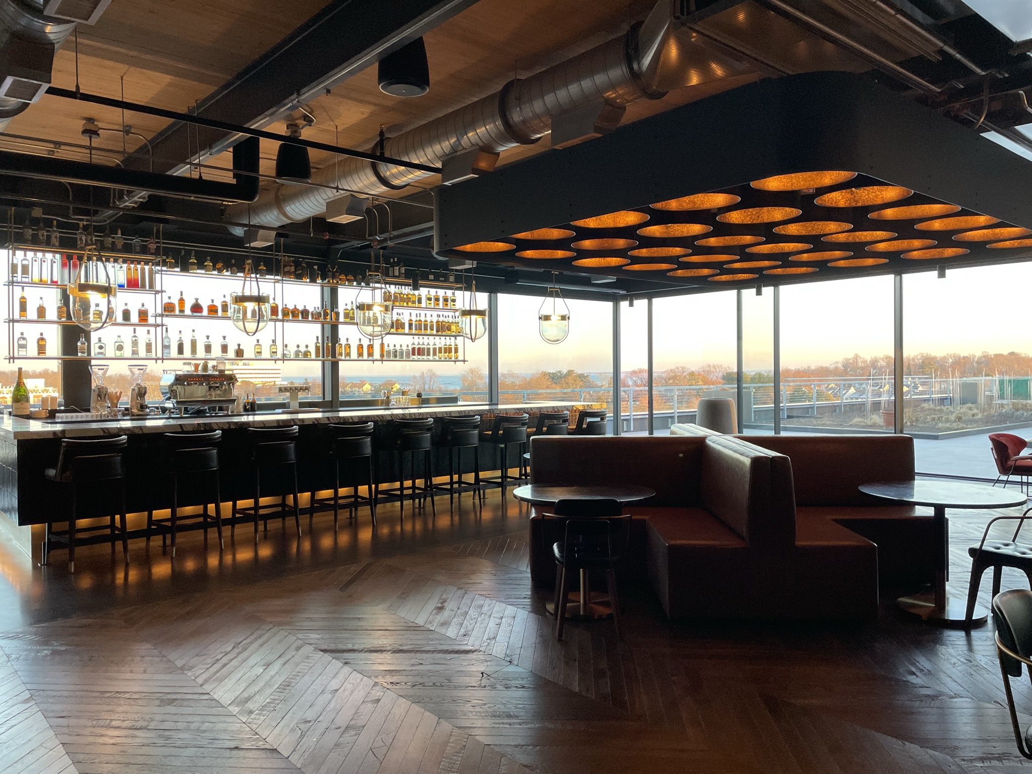 Wheelhouse at The Village rooftop bar with illuminated ceiling feature and skyline views