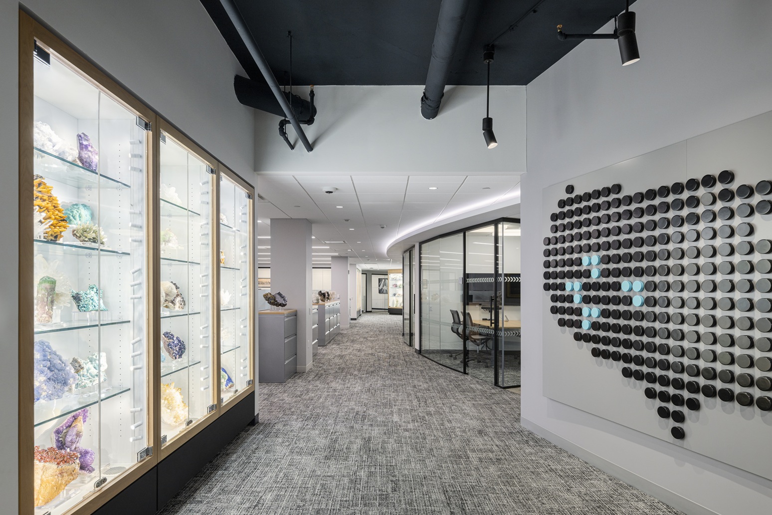 Illuminated geode display cabinets in MAXX Properties office