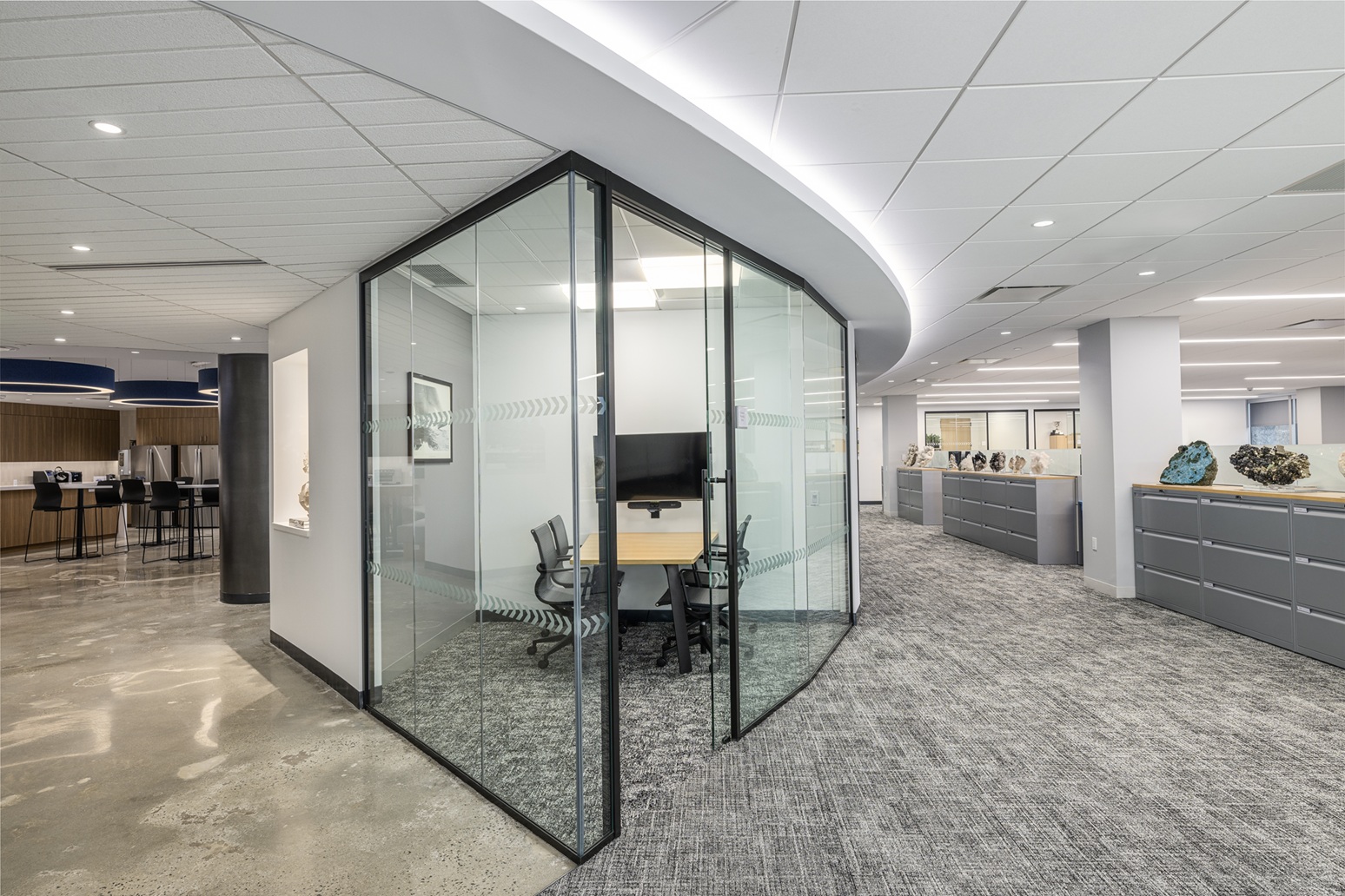 Glass conference room with integrated architectural lighting in modern office